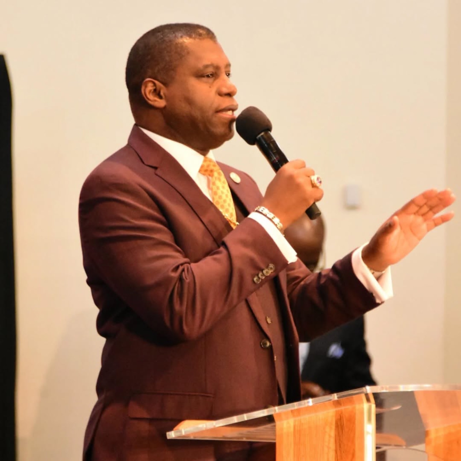 Bishop H. Curtis Douglas preaching with microphone in hand.