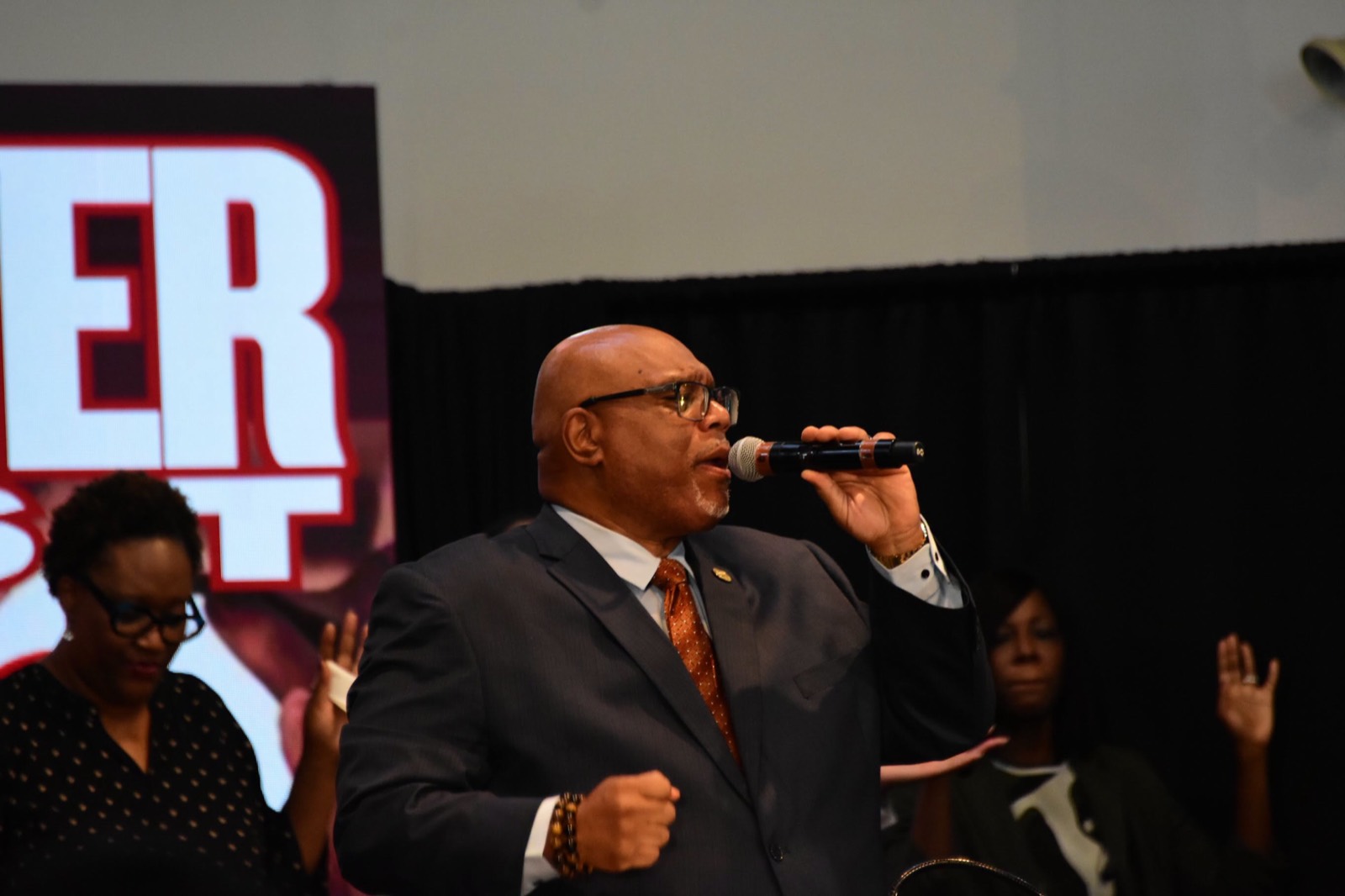 A minister sings with passion during worship.