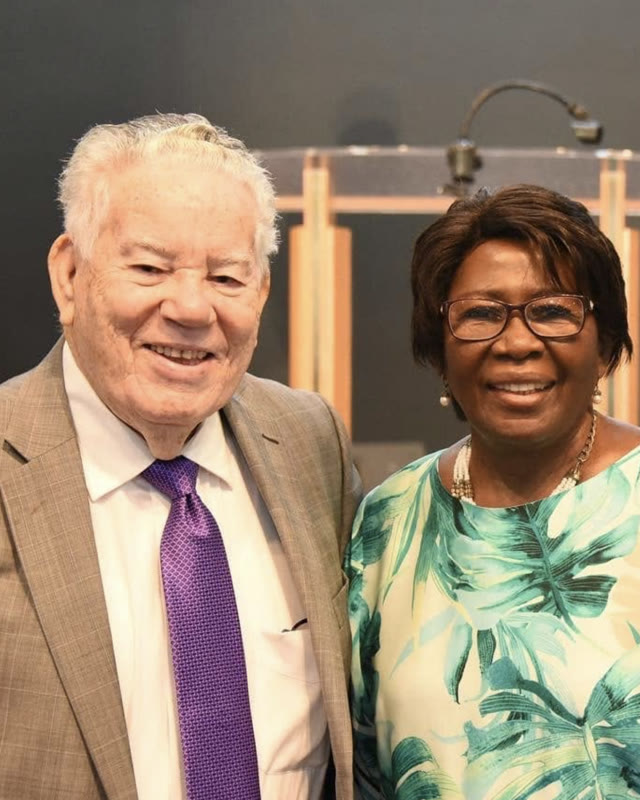 Overseer Stanley Kidd and Rev. Lenore Kidd smiling together in the sanctuary.
